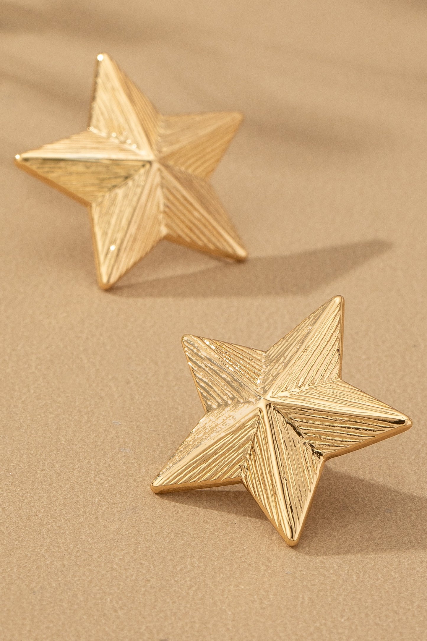 Textured star earrings
